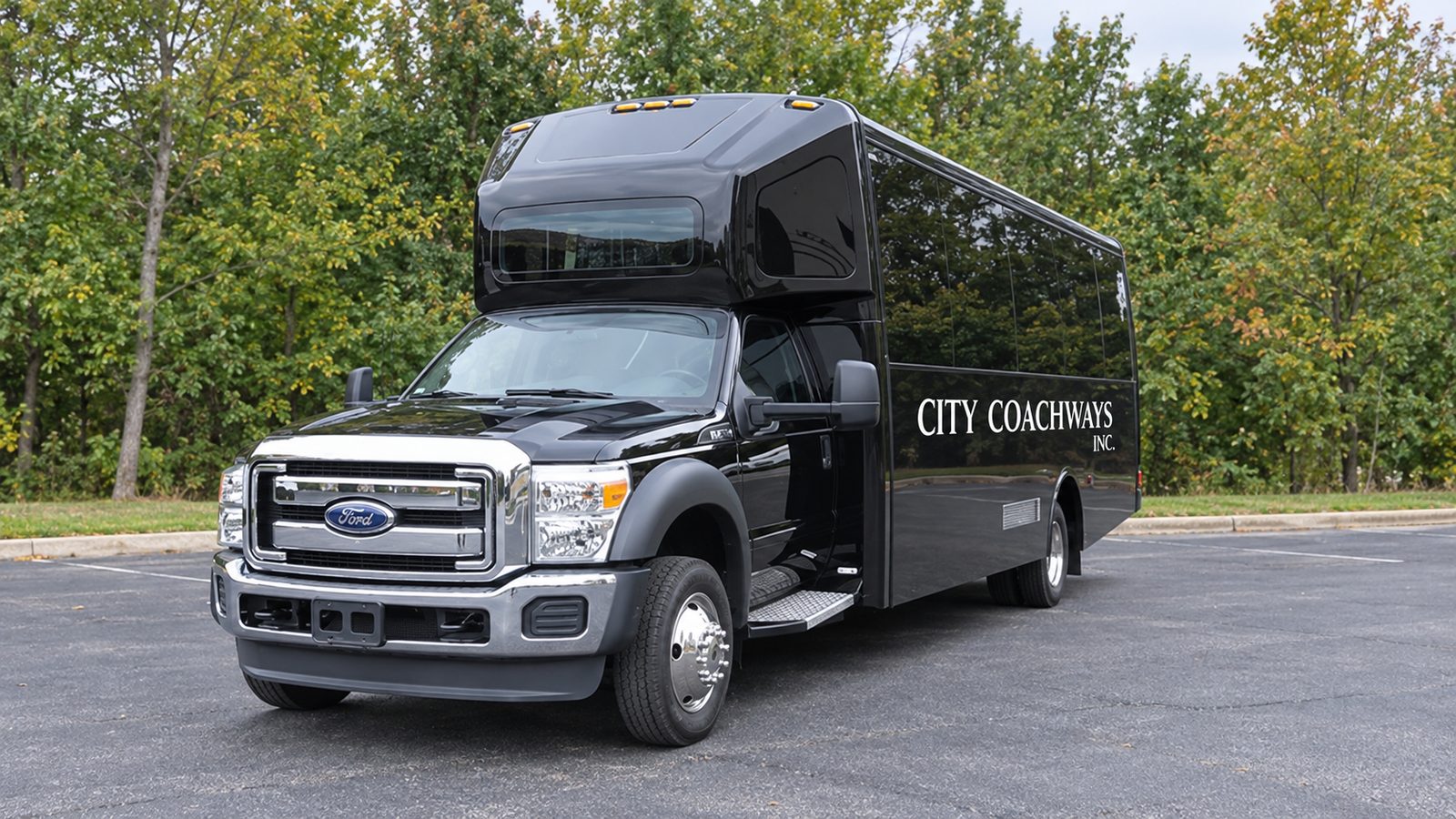 Black minibus with a chrome grille and white City Coachways side lettering