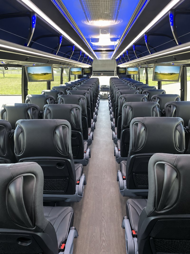 Coach seating viewed toward the front, with overhead luggage racks