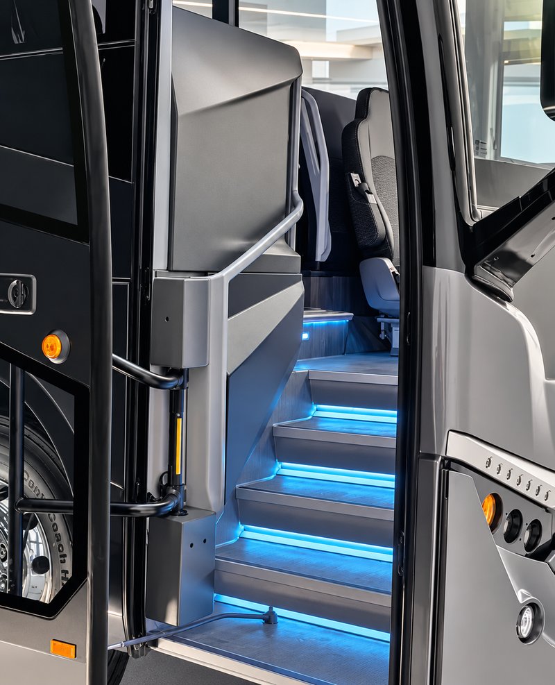 Coach entrance with handrails and blue-lit steps