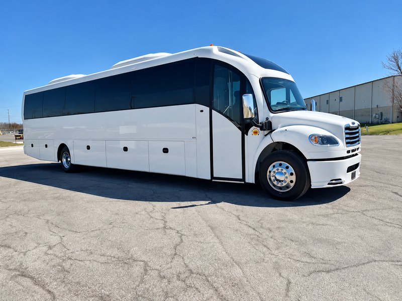 White executive minibus parked outdoors