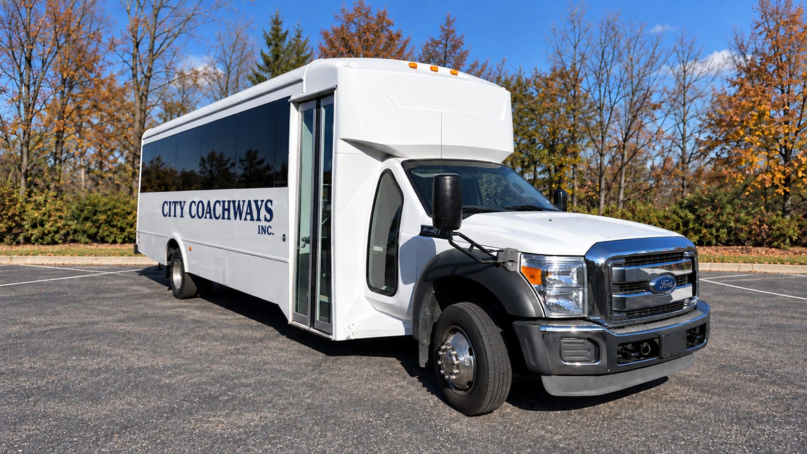 White minibus with dark windows, black front fenders, chrome grille, and City Coachways Inc. side lettering